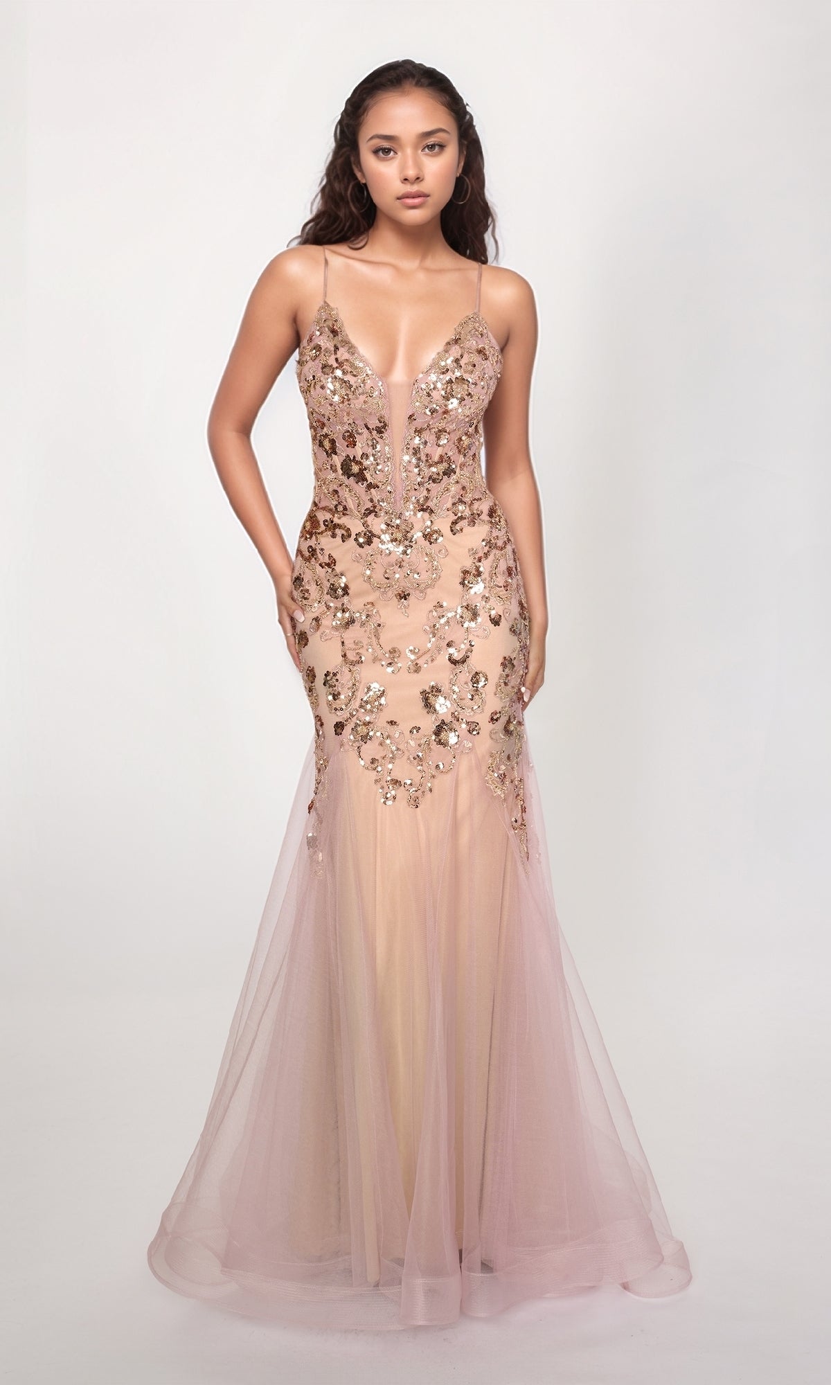 A woman wears the Nina Canacci 1576, a sleeveless long formal dress in light pink with sequin embellishments and a mermaid silhouette, posed against a plain white background.